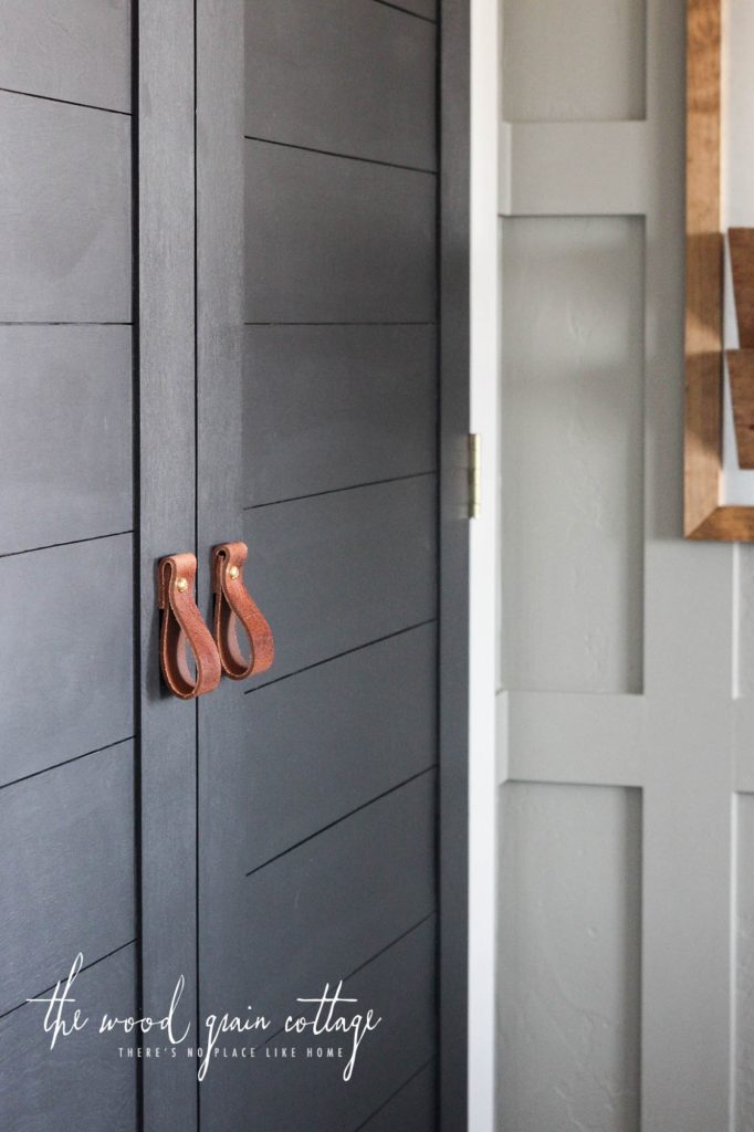 A picture of the finished closet doors with leather pulls.