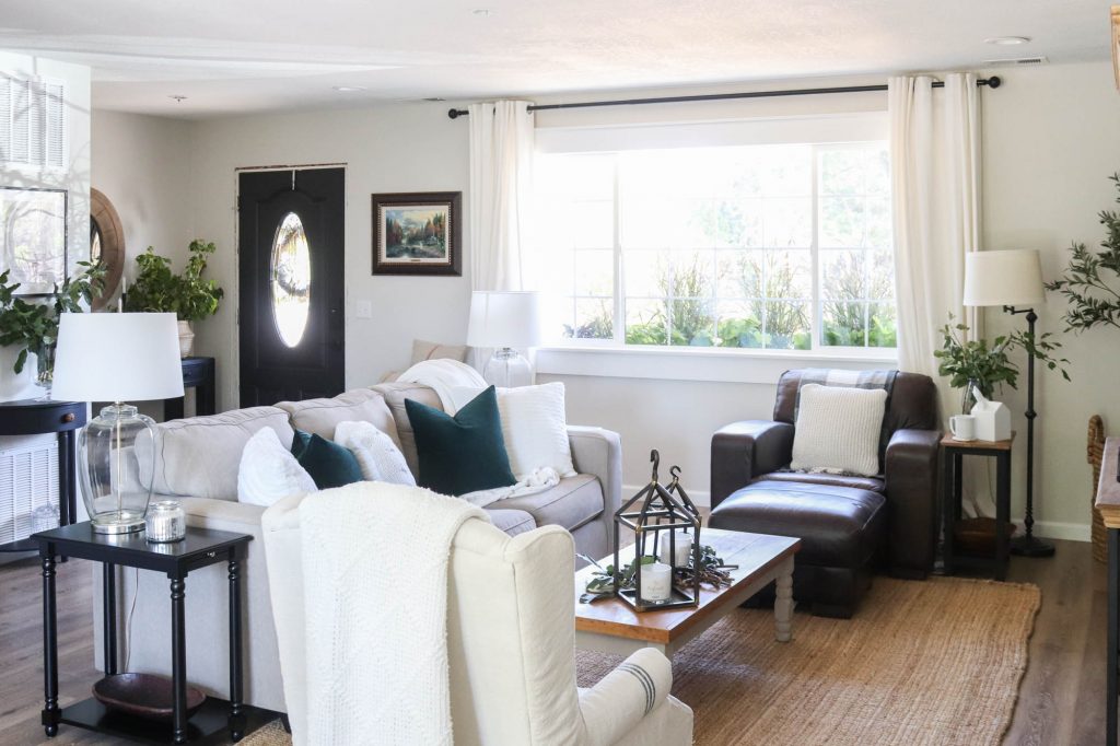 A picture of a living room with a couch and chair. 