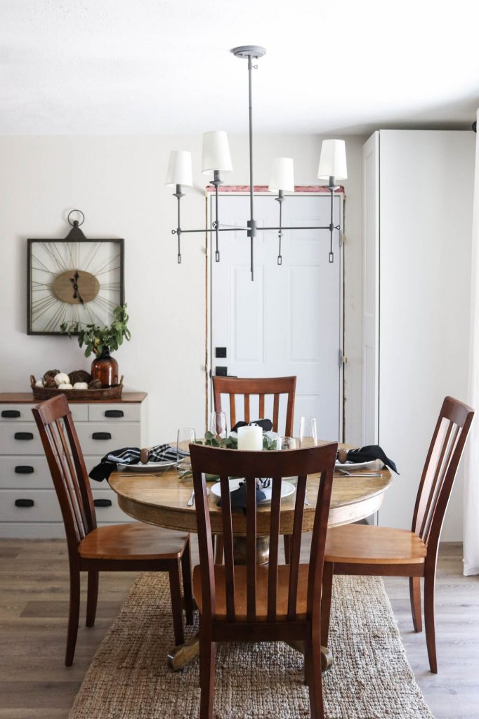 A picture of a dining room with a dining table and chandelier. 