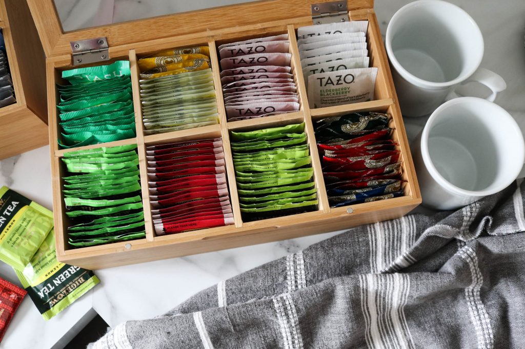 A picture of hot tea packets organized in a wooden box.