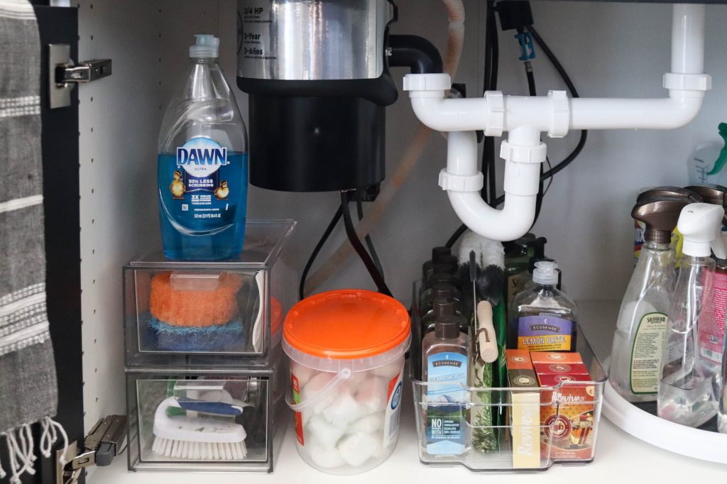 A picture showing the final outcome of organizing under the kitchen sink.