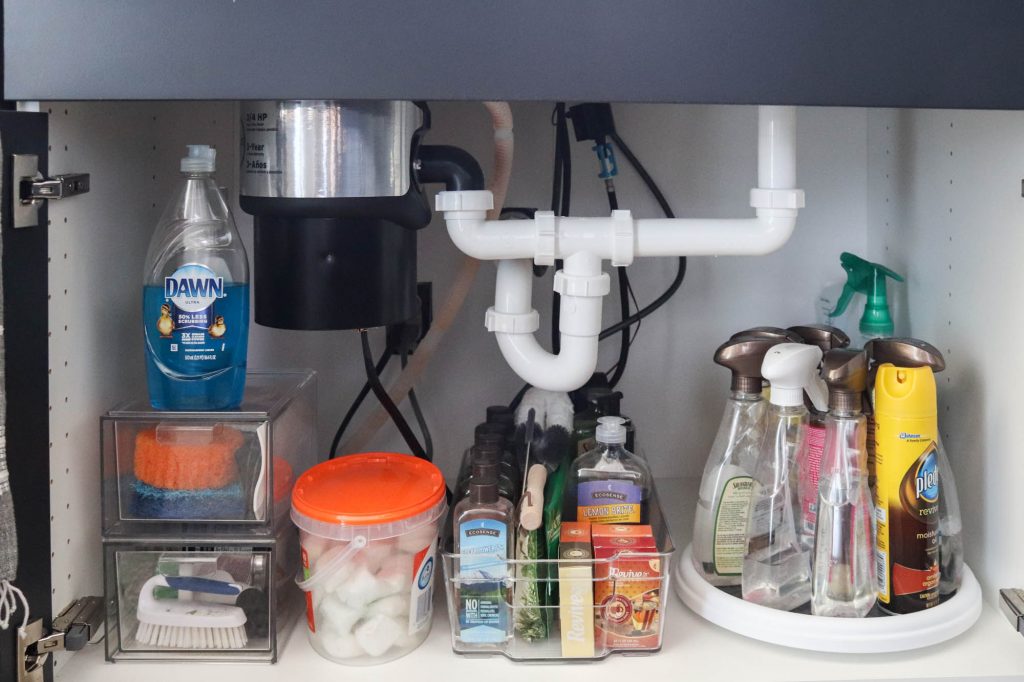 A picture showing the final outcome of organizing under the kitchen sink.