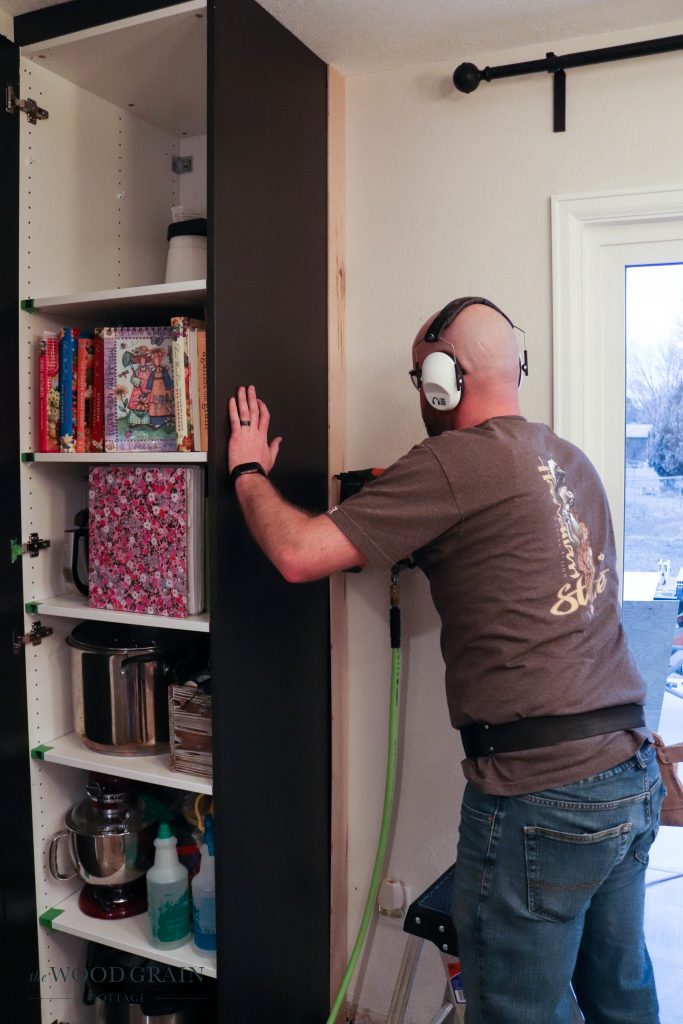 A picture of Todd nailing in the trim pieces. 