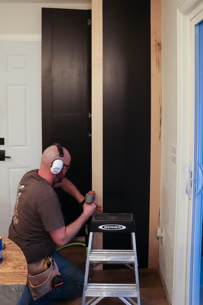 A picture of Todd nailing in the trim pieces. 