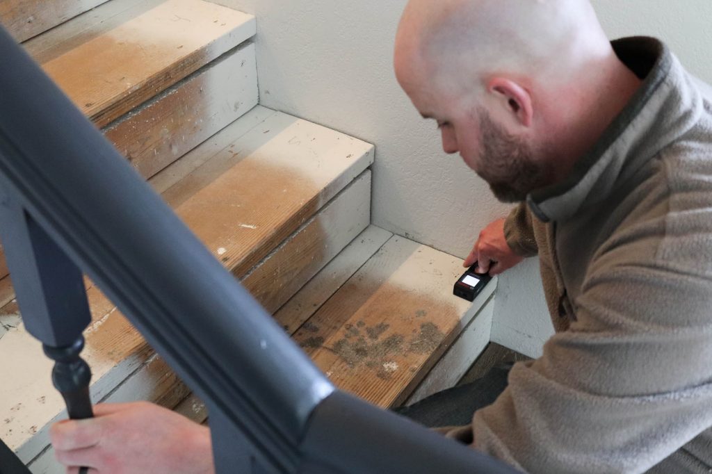 A picture of Todd measuring the stair step. 