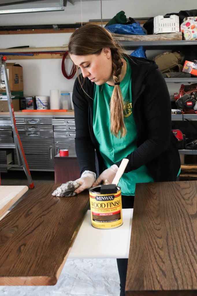 A picture of Shayna staining the stair treads. 