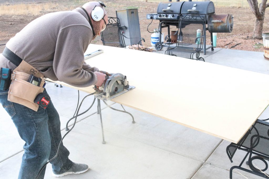 A picture of Todd ripping down the OSB for the stair risers. 