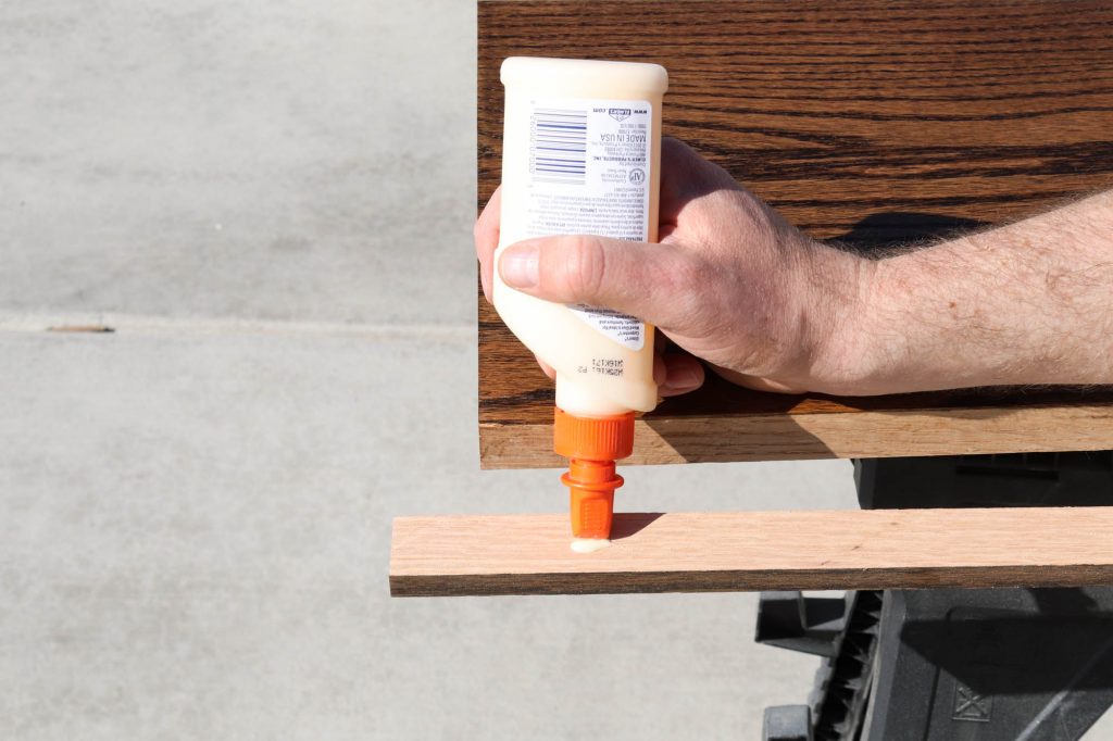 A picture showing Todd adding wood glue to the filler piece.