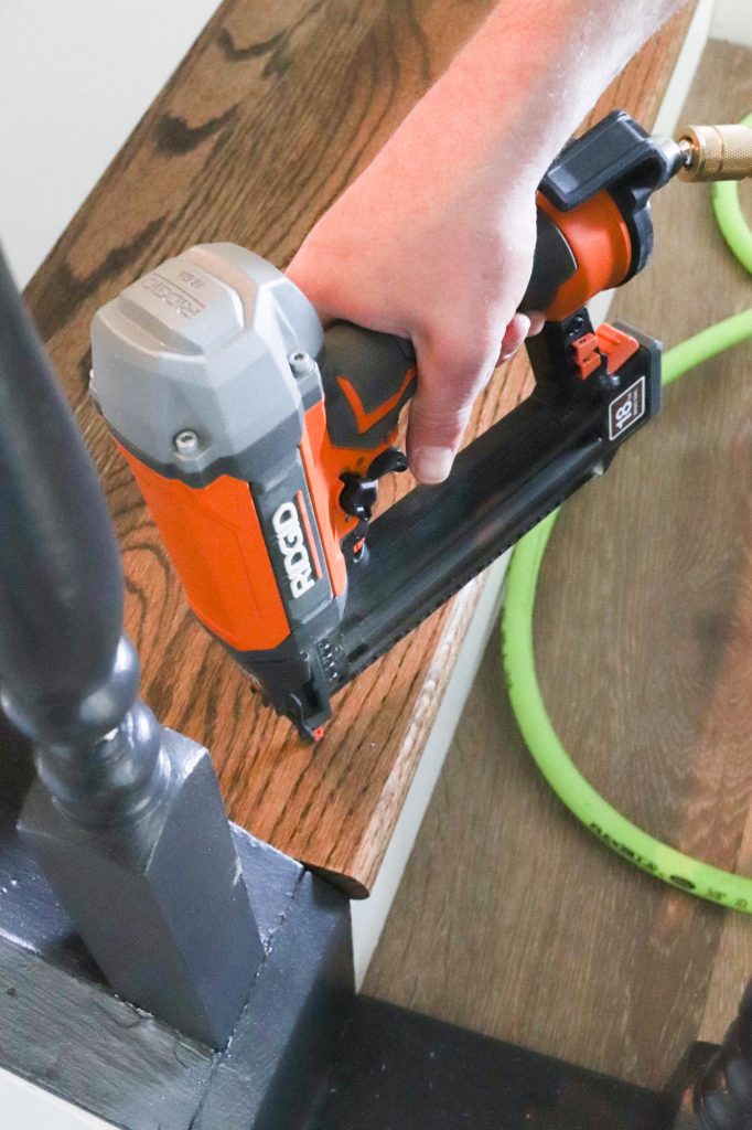 A picture of Todd nailing in a new stair tread. 