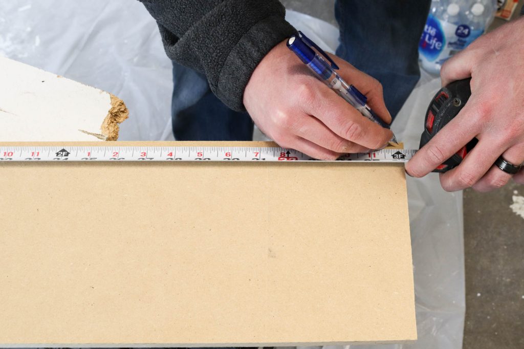 A picture of Todd measuring the cut riser to be trimmed to size. 