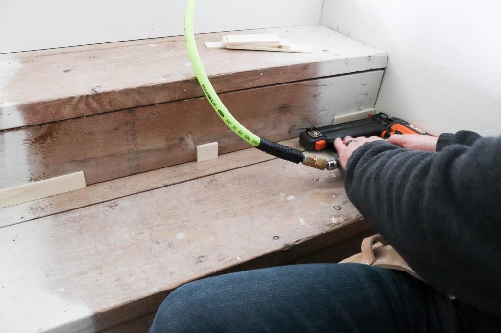 A picture of Todd installing shims on the existing riser. 