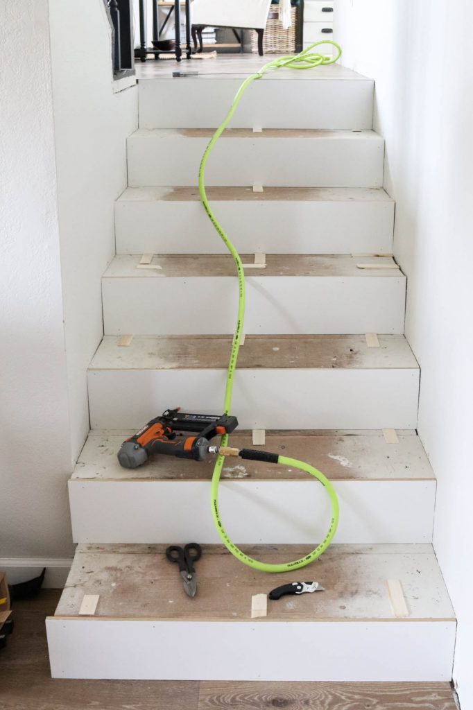 A picture of the stairs with shims nailed in place.