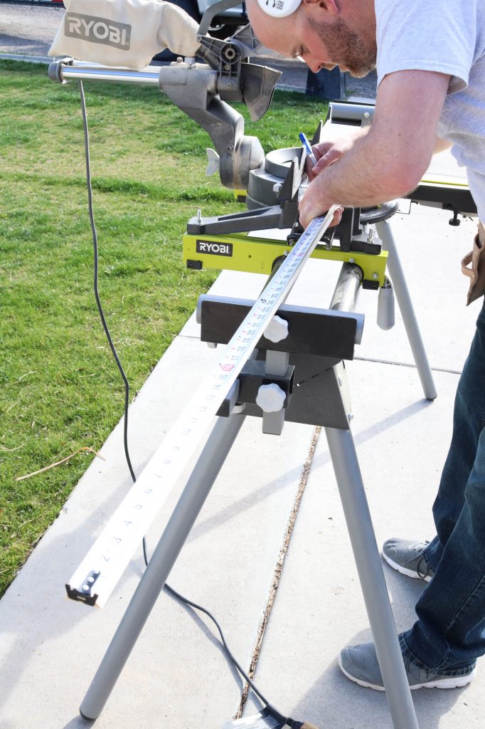 A picture of Todd measuring material to cut. 