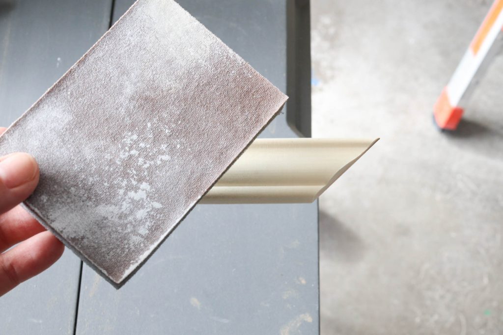 A picture showing the sanding process of the wood material. 