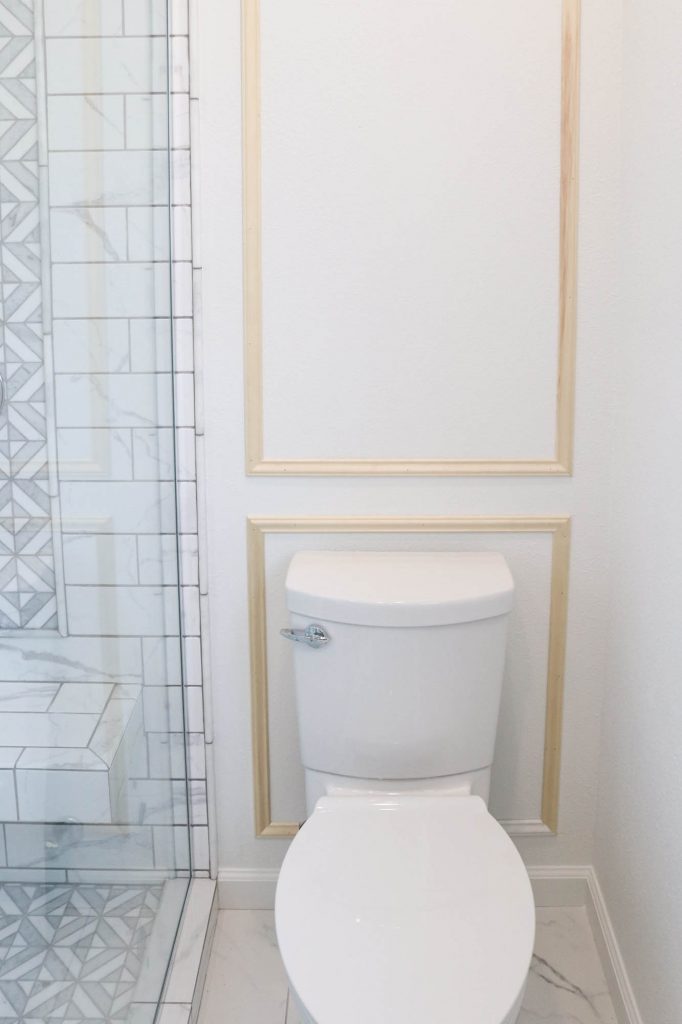 A picture of the toilet wall with moulding installed. 