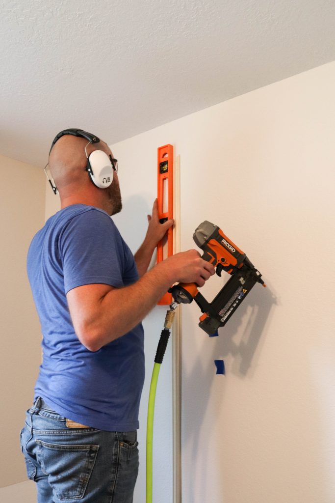 A picture of Todd installing the wall moulding. 