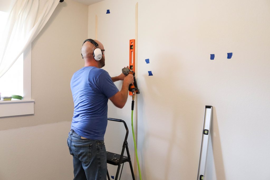 A picture of Todd installing the wall moulding. 