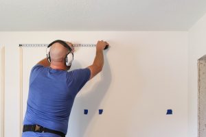 A picture of Todd installing the wall moulding.