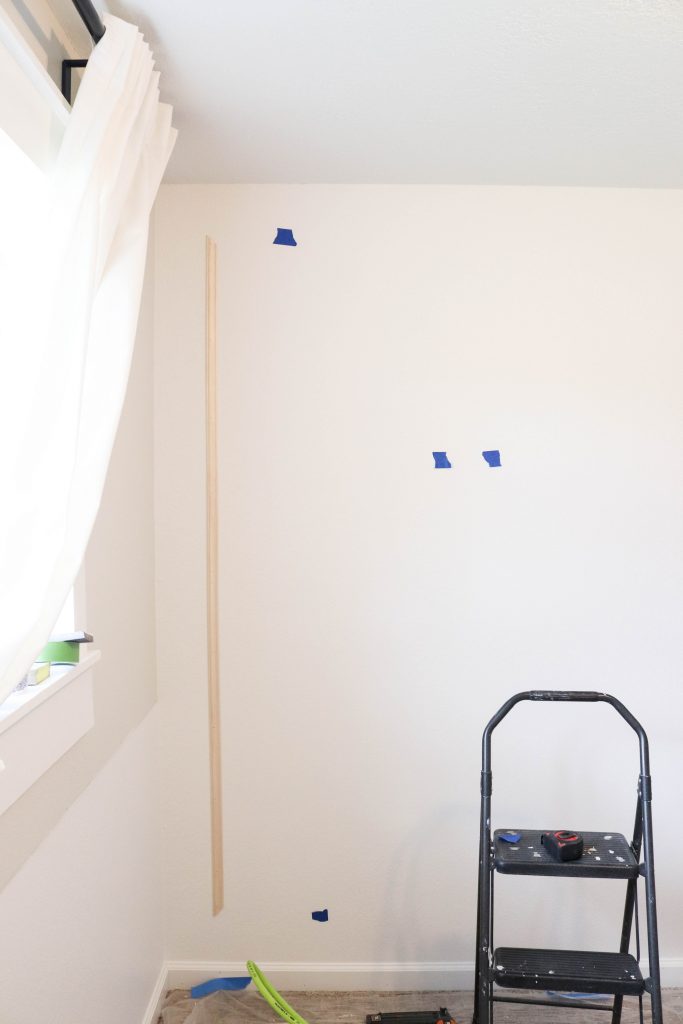 A picture of the wall with the first piece of moulding installed. 
