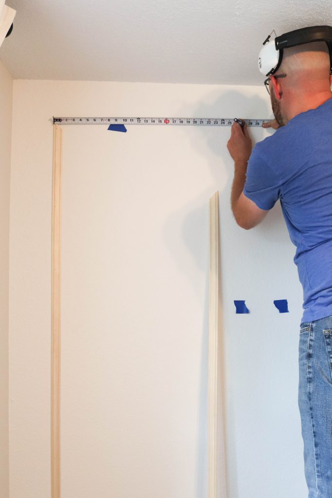 A picture of Todd installing the wall moulding. 