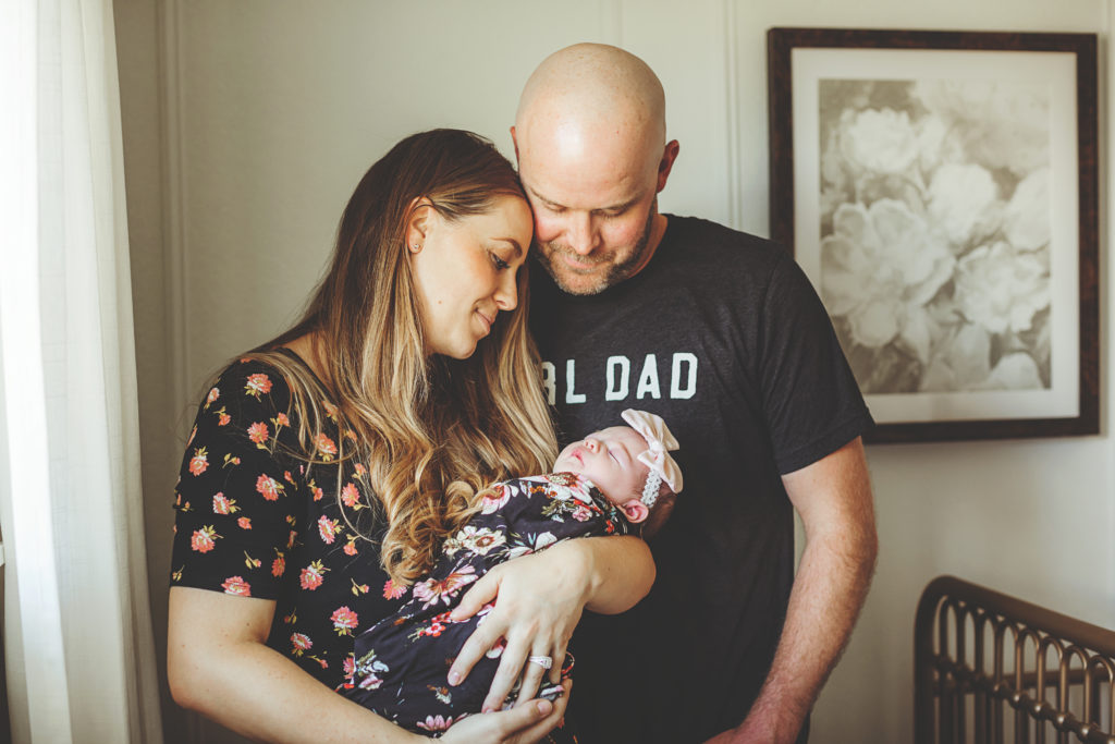 A picture of Todd and Shayna holding the baby.