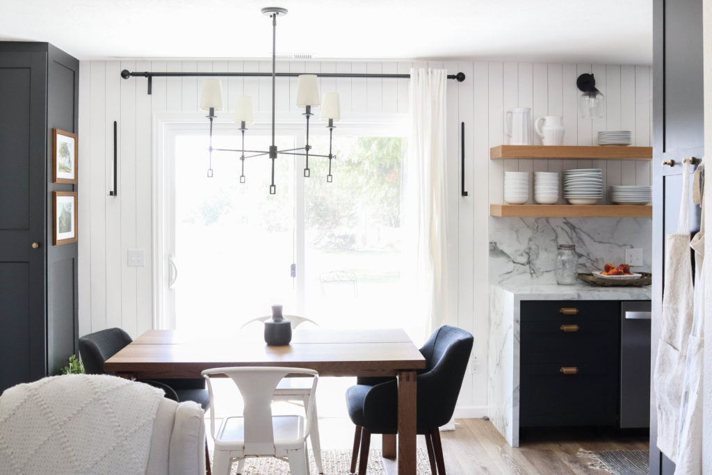 A picture of the kitchen and dining room with the new vertical planking and shelves. 
