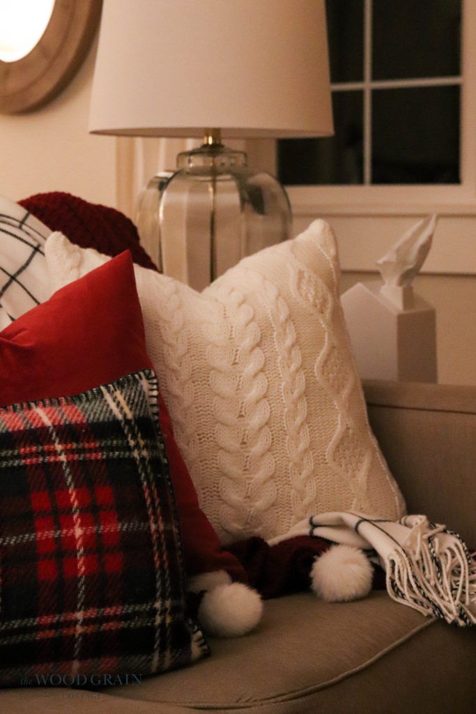 A picture of our couch with Christmas pillows. 