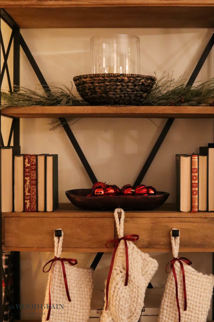 A picture of our living room open shelves decorated for Christmas. 