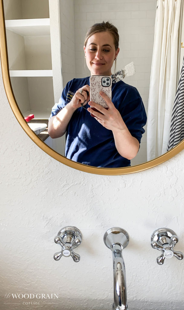 A picture of me painting the downstairs bathroom.