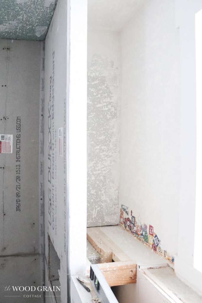 A picture of the shelves in the bathroom. 