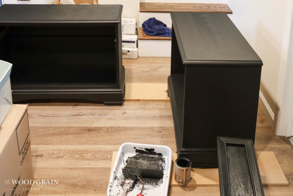 A picture of the night stands being painted black. 