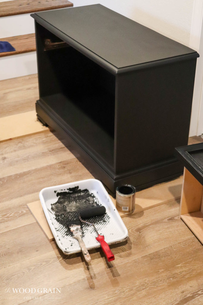 A picture of the night stands being painted black. 