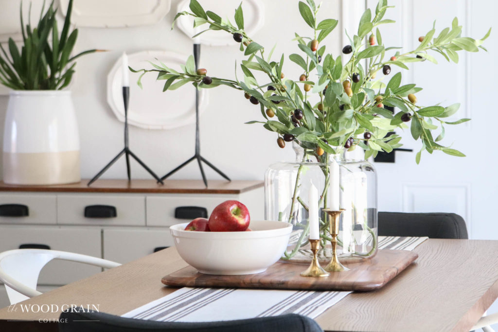 A picture of a clear vase on our dining room table.