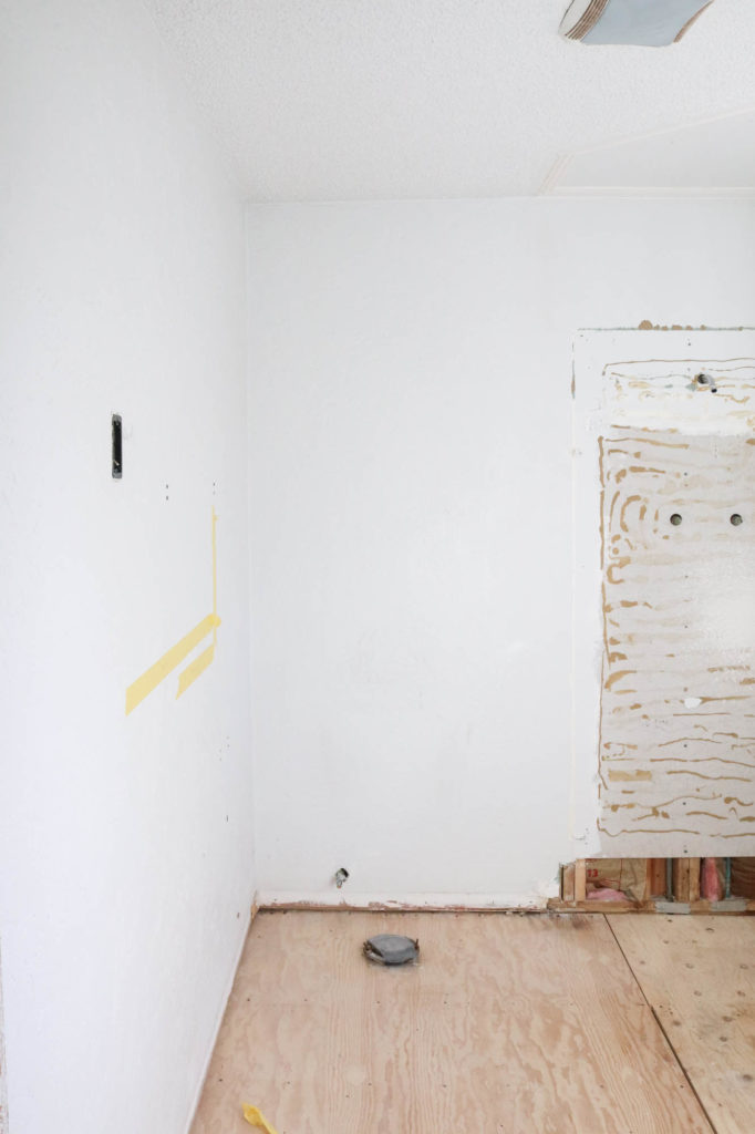 A picture of the bathroom gutted. 