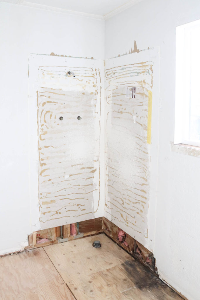 A picture of the master bathroom gutted. 