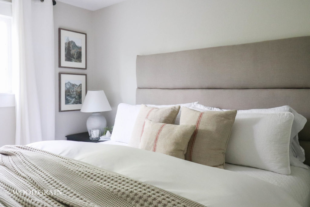A picture of the master bedroom with new artwork. 