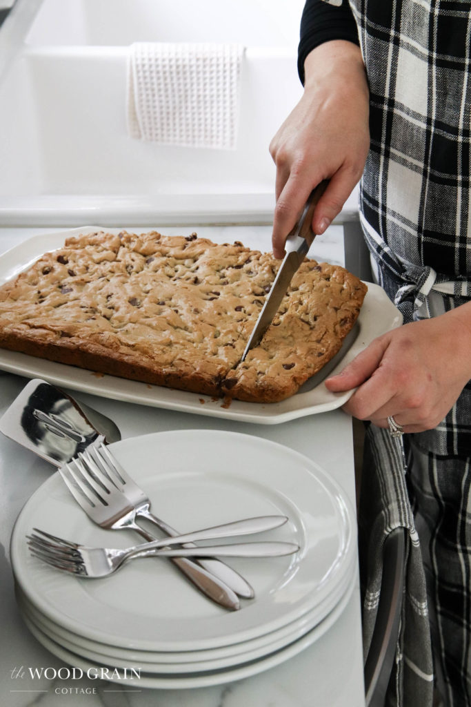 A picture of me cutting the toffee blondie bars. 