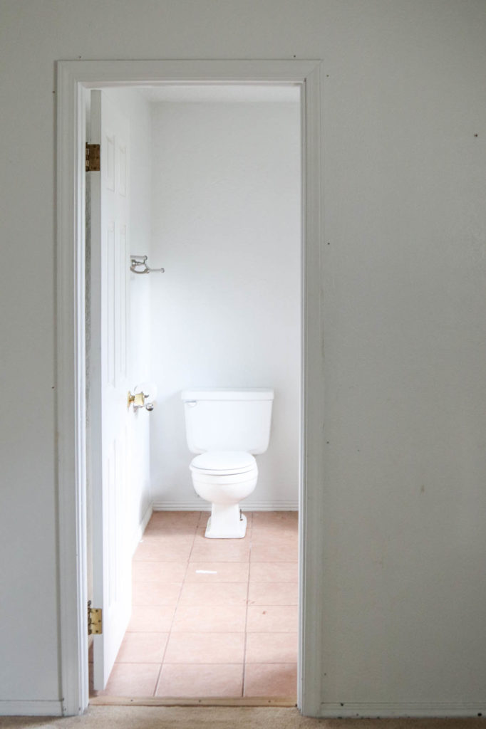 A picture of the bathroom doorway and the toilet. 