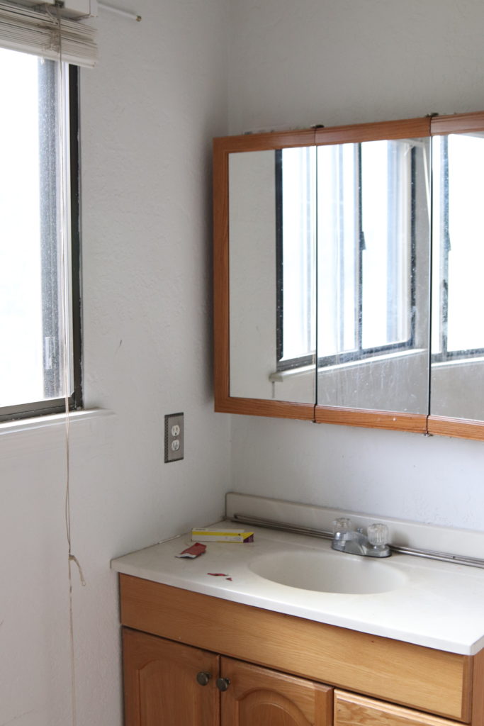 A picture of the bathroom vanity before. 
