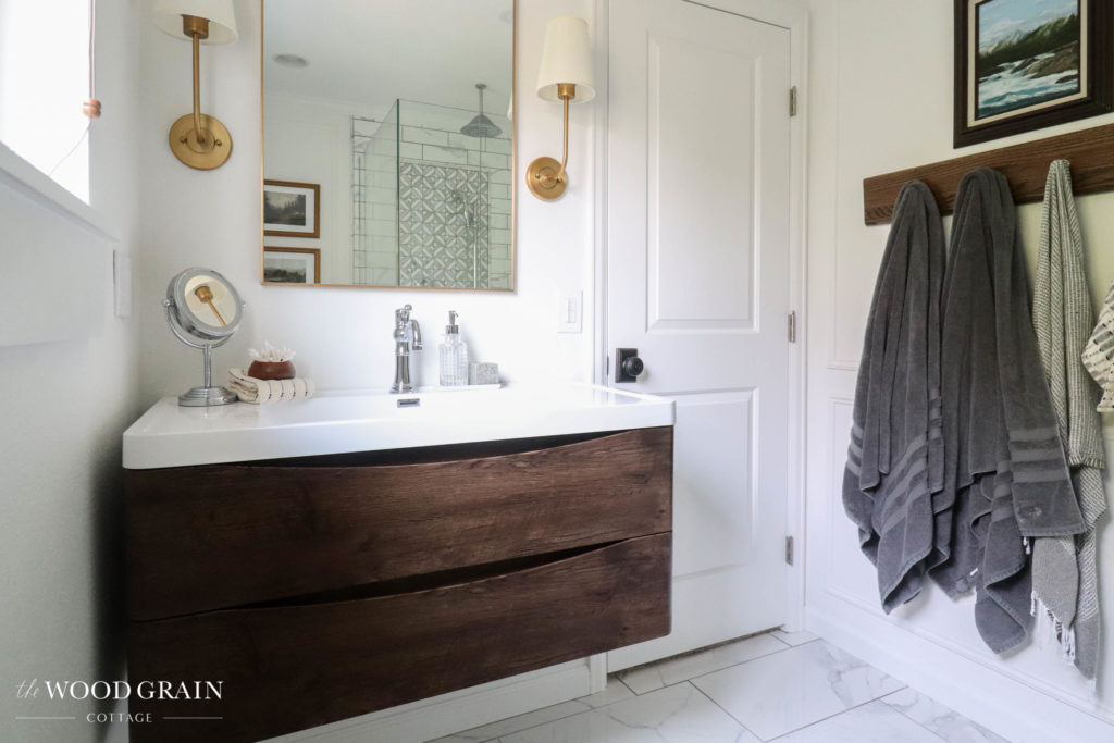 A picture of our bathroom showing the vanity and wall of towels. 