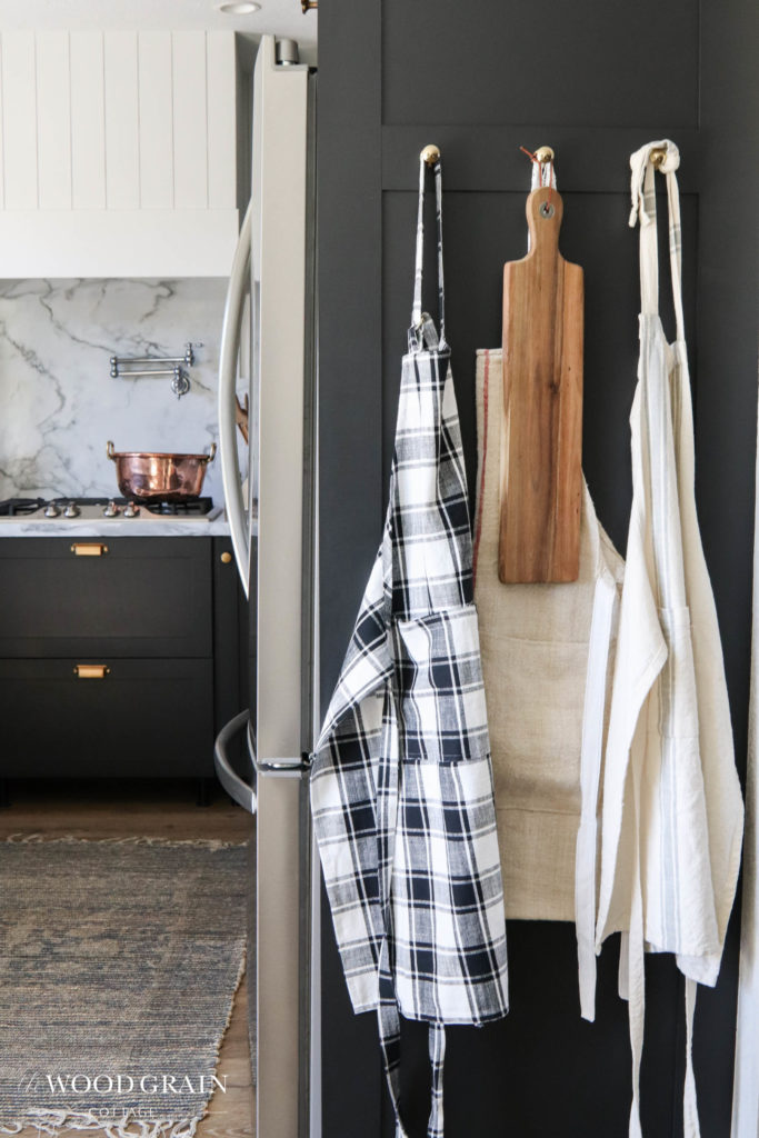 A picture of aprons hanging on the end panel. 