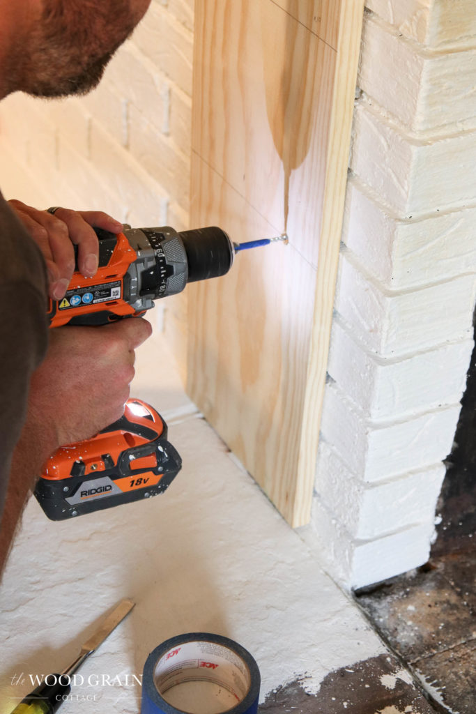 A picture of a concrete screw being installed in the brick.