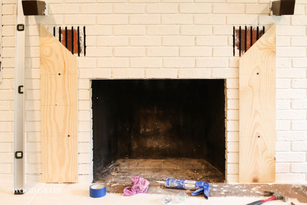 A picture of the trim work being installed around the fireplace. 