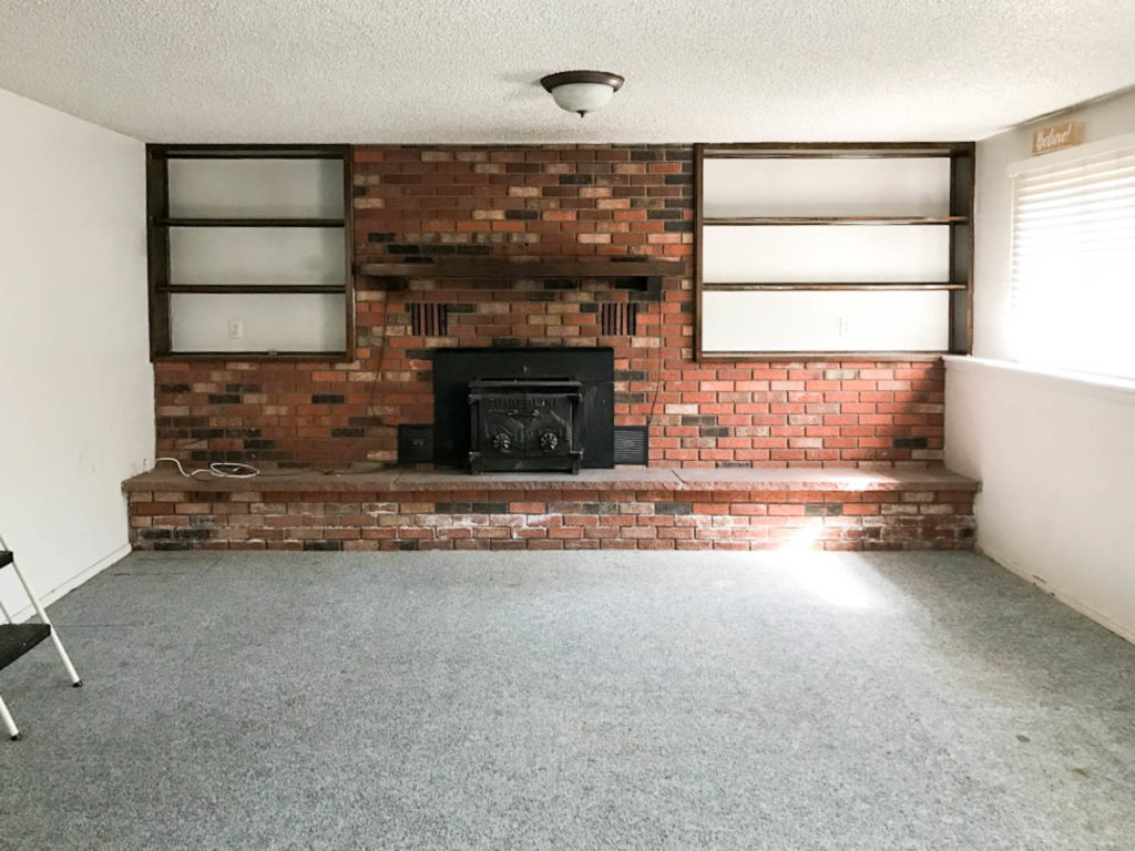 A picture of the brick fireplace before. 