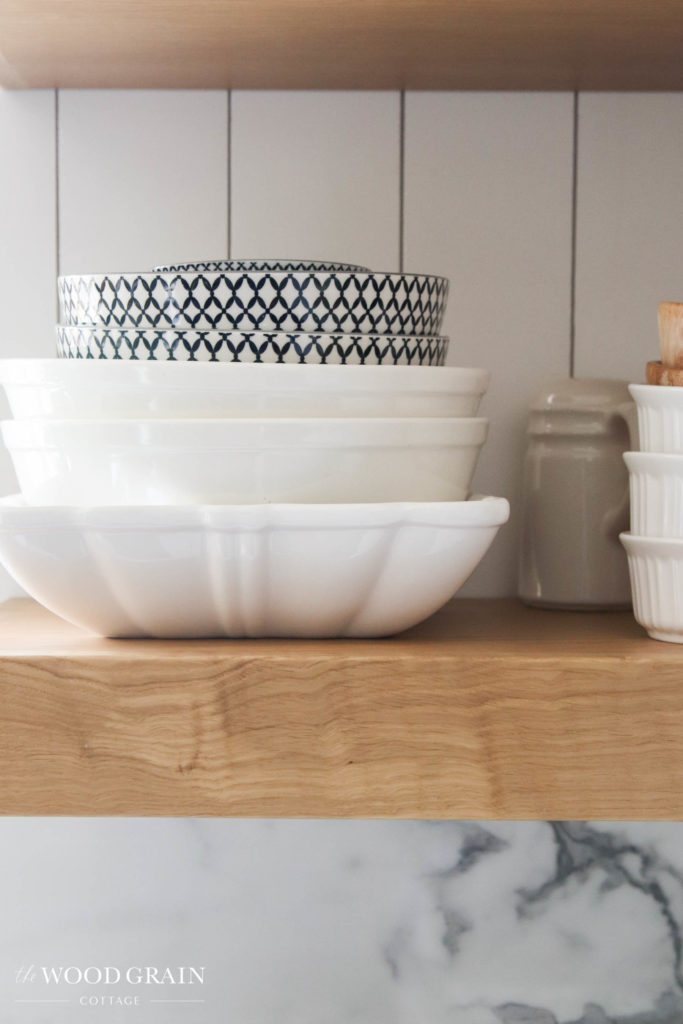 A picture of serving bowls on the open shelves. 