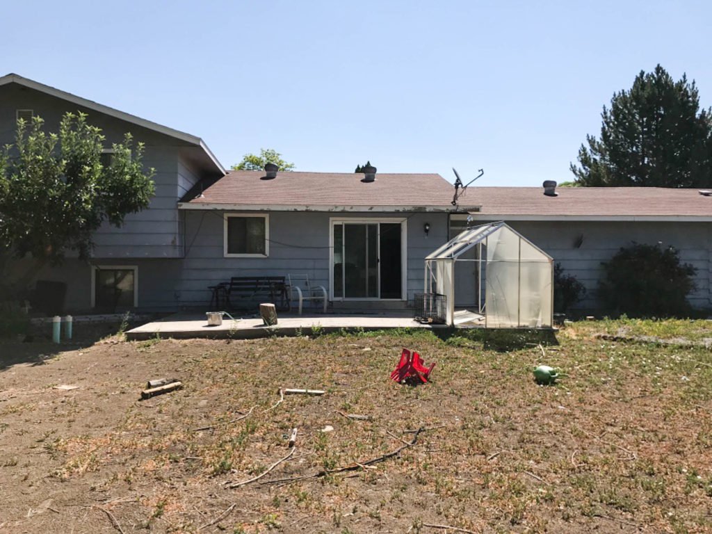 A picture of the back of the house when we bought it. 