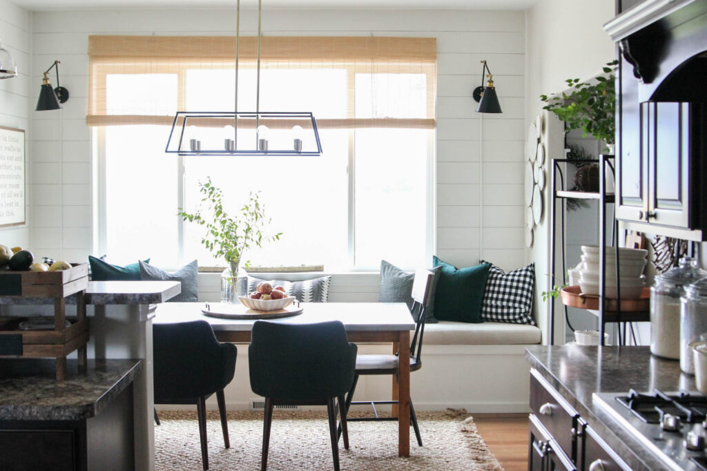 A picture of wall sconces on either side of a window. 