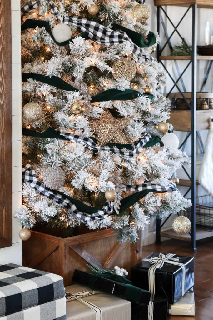 A close up picture of the tree with gold ornaments. 